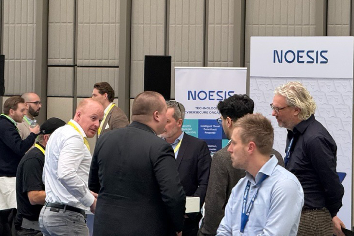 Attendees networking at the Noesis booth during the OpenText Summit Benelux 2026