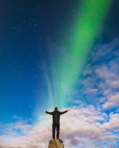 Man watching an aurora borealis represents a quality implementation methodologies