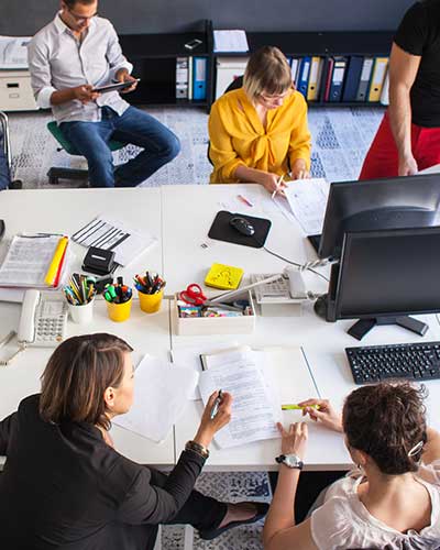 People Working Around a Desk represents our multidisciplinary teams