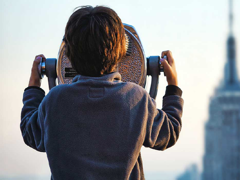 Kid using sightseeing binoculars represents our capacity to prevent all cyber attacks